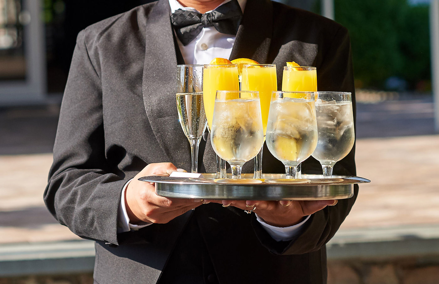 A Maître D' bringing beverages to the wedding party